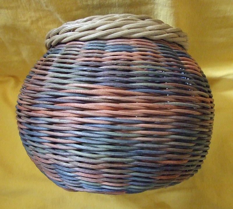 Step-dyed reed basket with fancy border